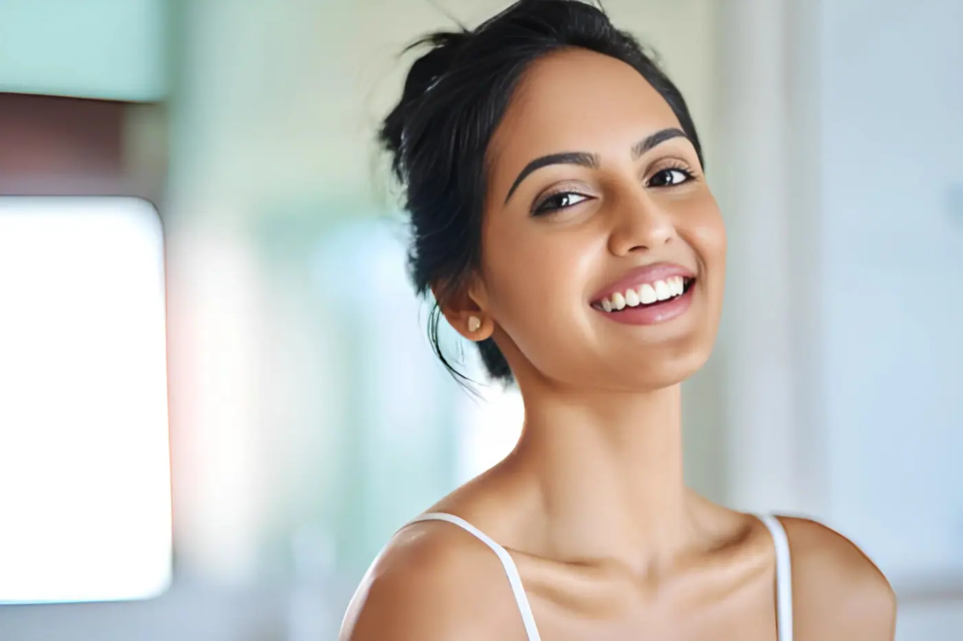 Woman smiling, shown to illustrate skin care